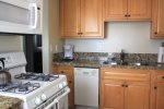 Fully stocked kitchen with gas stove, built-in microwave, dishwasher and everything else you need